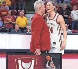  ?? ?? Iowa State coach Bill Fennelly greets Ashley Joens while presenting a framed jersey on senior day at Hilton Coliseum in 2023.