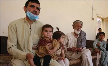  ?? Photo: AP ?? Tariq Nawaz holds his 10-month-old baby daughter Tuba who suffers from polio, in Suleiman Khel, Pakistan. For millions of people like Nawaz who live in poor and troubled regions of the world, the novel coronaviru­s is only the latest epidemic. They already face a plethora of fatal and crippling infectious diseases: polio, Ebola, cholera, dengue, tuberculos­is and malaria, to name a few. The diseases are made worse by chronic poverty that leads to malnutriti­on and violence that disrupts vaccinatio­n campaigns.