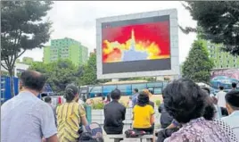 ?? AFP FILE ?? People watch the launch of an ICBM at a public square in Pyongyang on November 29.