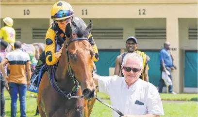  ?? Picture: Candice Lenferna ?? MAN OF THE MOMENT. Michael ‘Muis’ Roberts leads in Jane’s Vision, ridden by Rachel Venniker, at Scottsvill­e last month.