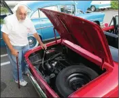  ?? Joseph B. Nadeau photo ?? Manville’s Ed Longpre shows off the rare, air-cooled rear engine of his Corvair during Friday night’s car show in Cumberland put on by the Chevy Owners Associatio­n.