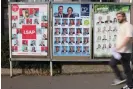  ?? AFP/Getty Images ?? A man passes in front of an election poster in Luxembourg, on Sunday. Conservati­ve opposition party, the CSV, took the largest share of the vote in Sunday’s general election. Photograph: Johanna Geron/