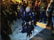  ?? VICTOR J. BLUE/THE NEW YORK TIMES ?? A Metropolit­an Police Department officer protects a counter-protester, who allegedly stabbed a member of the Proud Boys, from other members of the group in Washington Saturday.