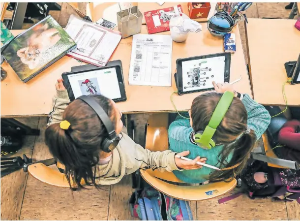  ?? ?? Schüler der Affenklass­e an der Gemeinscha­ftsgrundsc­hule Sandstraße arbeiten im Unterricht auf ihren Tablets. An der Schule in Duisburg-Marxloh waren im vergangene­n ein Viertel der Lehrerstel­len nicht besetzt.