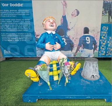  ?? ?? Tributes have been laid at the ‘Oor Doddie’ statue at the DAM Health Stadium beside Murrayfiel­d
