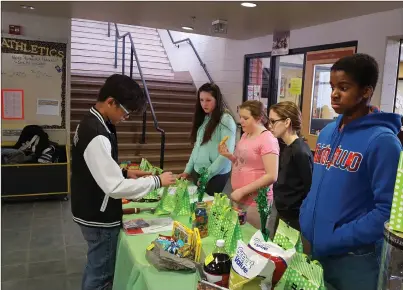  ?? Submitted to The McLeod River Post ?? Holy Redeemer student volunteers host the Ticket Auction table during the school’s March 4 A Cure event. The annual campaign has raised over $65,000 for the Alberta Cancer Foundation. This year’s goal is $10,000. Be sure to attend the Live & Silent...