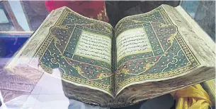  ?? PHOTO: ANUCHA CHAROENPO ?? A Quran, which had been damaged and restored, is displayed inside a glass box at the school.