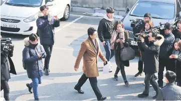  ??  ?? Members of the media surround a prosecutor attempting to enter the presidenti­al Blue House in Seoul. — AFP photo