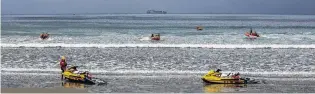  ?? PHOTO: NICKY THIRD ?? On the beach . . . Surf lifesavers using jet skis and inflatable rigid boats are put through their paces at Waikouaiti Beach during training exercises on Saturday.