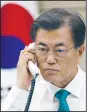  ?? AP/Yonhap ?? South Korean President Moon Jae-in holds a telephone conversati­on with Japanese Prime Minister Shinzo Abe on Friday to discuss North Korea’s missile launch at the Presidenti­al Blue House in Seoul, South Korea.