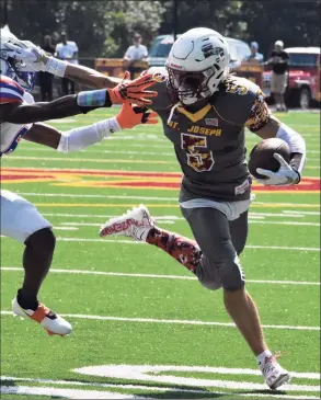  ?? Pete Paguaga, / Hearst Connecticu­t Media ?? St. Joseph’s Maxwell Warren breaks a tackle against Danbury on Saturday in Trumbull.