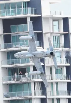  ?? Picture: RICHARD GOSLING ?? A jet swoops through Surfers Paradise for a closer look over preparatio­ns for the GC600.