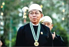  ?? SAI AUNG MAIN/AFP THET AUNG/AFP ?? Min Aung Hlaing arrives to attend a reception to mark the 72nd anniversar­y of the country’s National Union Day in Naypyidaw on February 12.