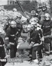  ?? — AP ?? Firemen rescue a victim from the rubble of a building in Rosny- sous- Bois, outside Paris, on Sunday. A four- storey residentia­l building collapsed following an explosion, possibly due to a gas leak, killing seven people, and leaving at least 11...