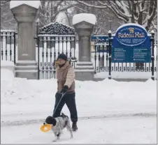  ?? The Canadian Press ?? A man walks his dog past the gates to Rideau Hall, official residence of the governor general, on Thursday. A report on the toxic work environmen­t inside the Rideau Hall office forced Julie Payette to resign.