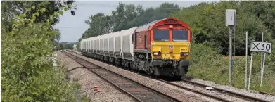  ?? JEREMY CALDECOAT. ?? DB Cargo 66114 passes Horse Fen Crossing (near Soham) on July 5, with the 0851 Mountsorre­l-Barham aggregates train. Class 66s are halfway through their working careers, according to DB’s chief executive, with the company currently entertaini­ng no replacemen­t plans.