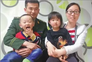  ?? PHOTOS PROVIDED TO CHINA DAILY ?? Zhao Lujie and Gu Suli with their two children at home in Beiji village, Heilongjia­ng province.