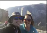  ?? SEAN MATTESON VIA AP ?? Sean Matteson poses for a selfie with his girlfriend, Drea Rose Laguillo, in Yosemite National Park. The couple said Meenakshi Moorthy, the pink-haired woman seen in background at left, accidental­ly appeared in two of their photos taken shortly before the 30-year-old old Moorthy fell to her death from a popular overlook in Yosemite.