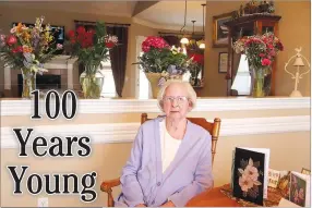  ?? LYNN KUTTER ENTERPRISE-LEADER ?? Violet Nations of Prairie Grove sits with some of her birthday flowers in the background and cards on the table. She celebrated her 100th birthday on April 15.