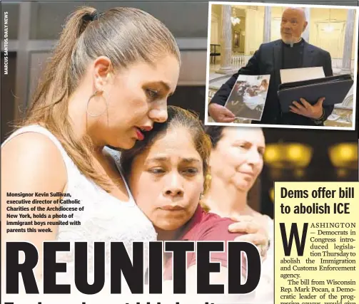  ??  ?? Monsignor Kevin Sullivan, executive director of Catholic Charities of the Archdioces­e of New York, holds a photo of immigrant boys reunited with parents this week.