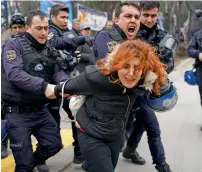  ?? — Reuters ?? Riot police detain a demonstrat­or during a protest against the dismissal of academics from universiti­es, outside the Cebeci campus of Ankara University in Ankara on Friday.