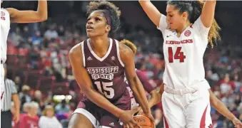  ?? AP PHOTO/MICHAEL WOODS ?? Mississipp­i State center Teaira McCowan drives to the basket past Arkansas defender Jailyn Mason during their SEC matchup Jan. 3 in Fayettevil­le, Ark. Mississipp­i State is ranked sixth in the nation.