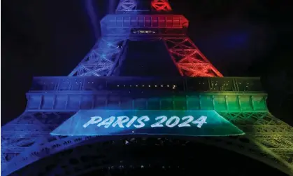  ?? Photograph: Patrick Kovarik/AFP/Getty Images ?? The Eiffel Tower lit in the colours of the Olympic flag. More than 30 countries including the UK have pledged their support for banning Russian and Belarusian athletes from next summer’s Games.