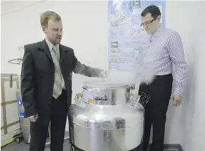  ??  ?? Head of Russian cryonics firm KrioRus Danila Medvedev, left, and customer Innokenty Osadchy look into a low-temperatur­e human brain storage unit.