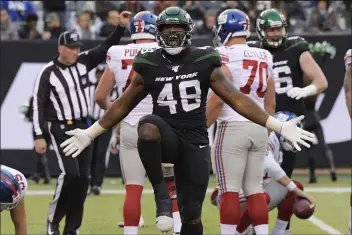  ?? BILL KOSTROUN — THE ASSOCIATED PRESS ?? Jets outside linebacker Jordan Jenkins celebrates after making a play Sunday against the Giants.