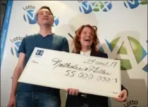  ?? RYAN REMIORZ, THE CANADIAN PRESS ?? Nathalie Langlais and Gilles Rosnen hold their winning $55-million lottery cheque in Montreal on Monday.