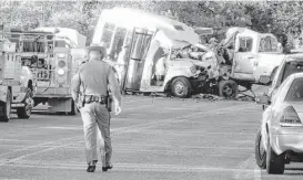  ?? Zeke MacCormack / San Antonio Express-News ?? Uvalde County authoritie­s investigat­e a collision that killed 13 people on a church bus near Garner State Park on Wednesday.