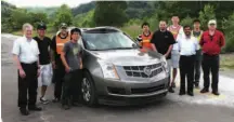  ??  ?? Left: Boss, Carnegie Mellon University’s DARPA Challenge-winning autonomous vehicle. Above: CMU’S Professor Raj Rajkumar (third from right) is pictured with colleagues, General Motors officials and a Cadillac SRX test vehicle celebratin­g GM’S agreement...