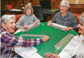  ??  ?? A group enjoys a game at the community center at The Heritage at Towne Lake. Shown, from left, are Barbara Navadel, Cathy Scroggins, Mary Ewing and Allie Murphree.