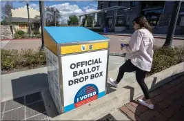  ?? HANS GUTKNECHT — STAFF PHOTOGRAPH­ER ?? Cindy Martinez drops off her ballot at the Old Town Newhall Library in Santa Clarita on Monday. Drop boxes and vote centers will be open until 8 p.m. today.