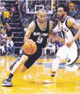  ?? Frederick Breedon / Getty Images ?? The Spurs’ Tony Parker drives past Mike Conley of the Grizzlies en route to 27 points.