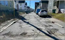  ?? MELANIE GILBERT — LOWELL SUN ?? Potholes and broken pavement line the length of Smith Avenue between Middlesex and Branch Streets in Lowell, seen here on March 8, 2024, which residents say hasn’t been paved in 30 years.