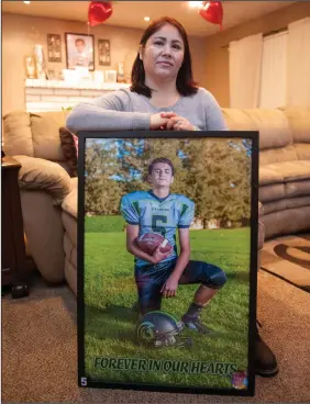  ?? BEA AHBECK/NEWS-SENTINEL ?? In Lodi on Friday, Silvia Van Steyn holds an image of her son, Michael Balsley-Rodriguez, taken in 2016 when he was 13 years old.