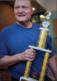  ?? ?? Bishop holds the trophy, which was recently won by the Reeds Brook Middle School chess team in a national competitio­n.