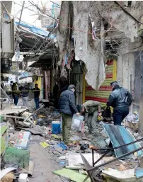  ?? Reuters ?? Iraqi security forces inspect the site of a bomb attack at a market in central Baghdad on Saturday. —