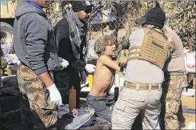  ?? KHALID MOHAMMED / ASSOCIATED PRESS ?? Army paramedics give first aid Sunday to displaced civilians who were injured in a mortar attack by Islamic State forces during fighting between Iraqi security forces and militants on the western side of Mosul, Iraq.