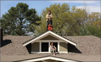  ?? (Special to the Democrat-Gazette/Jamie Harmon) ?? Pine-Bluff native Mark Edgar Stuart hangs out on his roof in Memphis with his wife when times get tough. The singersong­writer is livestream­ing a show Wednesday night on his Facebook page.