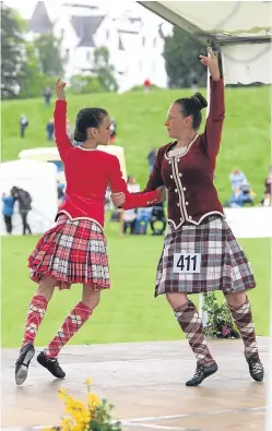  ?? Pictures: Phil Hannah. ?? The march of the Atholl Highlander­s, top, and games staples Highland dancing and caber toss.