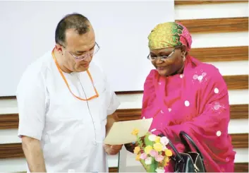  ??  ?? The Vice Chancellor, Nile University of Nigeria, Professor Heseyin Sert (left) and Director Federal Scholarshi­p Board, Mrs Fatima Jiddum study a document at the event