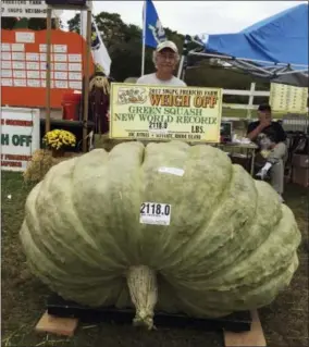  ?? SUSAN JUTRAS VIA AP ?? In this Oct. 7, 2017, photo provided by Susan Jutras, Joe Jutras stands with his world record breaking, 2,118-pound squash, following a weigh-in at Frerichs Farm in Warren, R.I. Jutras has become the first grower in the world to achieve a trifecta in...