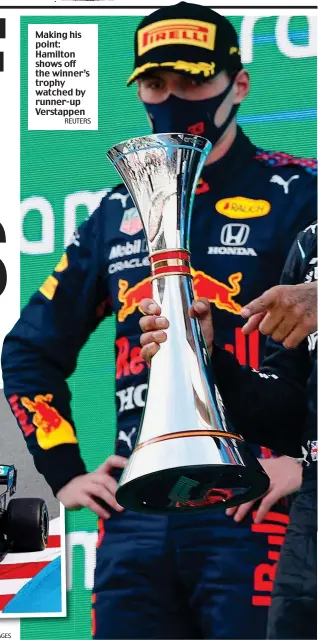  ?? REUTERS ?? Making his point: Hamilton shows off the winner’s trophy watched by runner-up Verstappen