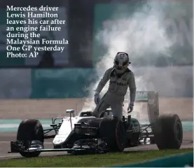  ??  ?? Mercedes driver Lewis Hamilton leaves his car after an engine failure during the Malaysian Formula One GP yesterday Photo: AP