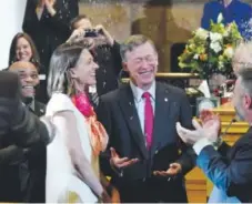  ??  ?? Legislator­s surprise Gov. John Hickenloop­er and his fiancée, Robin Pringle, by throwing rice on the couple after the governor’s annual State of the State address. Helen H. Richardson, The Denver Post