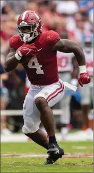  ?? (AP/Vasha Hunt) ?? Alabama running back Brian Robinson Jr. rushed for a career-high 171 yards and 4 touchdowns as the top-ranked Crimson Tide defeated No. 12 Ole Miss 42-21 on Saturday in Tuscaloosa, Ala. It was Robinson’s first 100-yard game for the Crimson Tide.