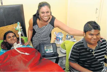  ?? Picture: MARK WING ?? Claudette Sigamoney with her sons, Tyronne and Clerrade, who both have muscular dystrophy. Tyronne is now permanentl­y on a portable ventilator