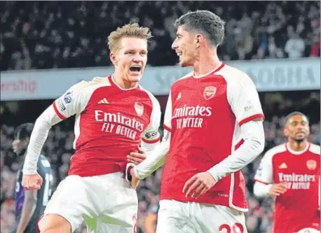  ?? AP ?? Arsenal's Martin Odegaard (left) celebrates with Kai Havertz after scoring during the English Premier League match against Luton Town.